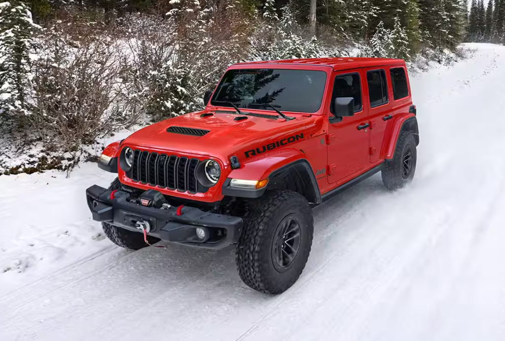 Red 2026 Jeep Wrangler Rubicon driving in snow